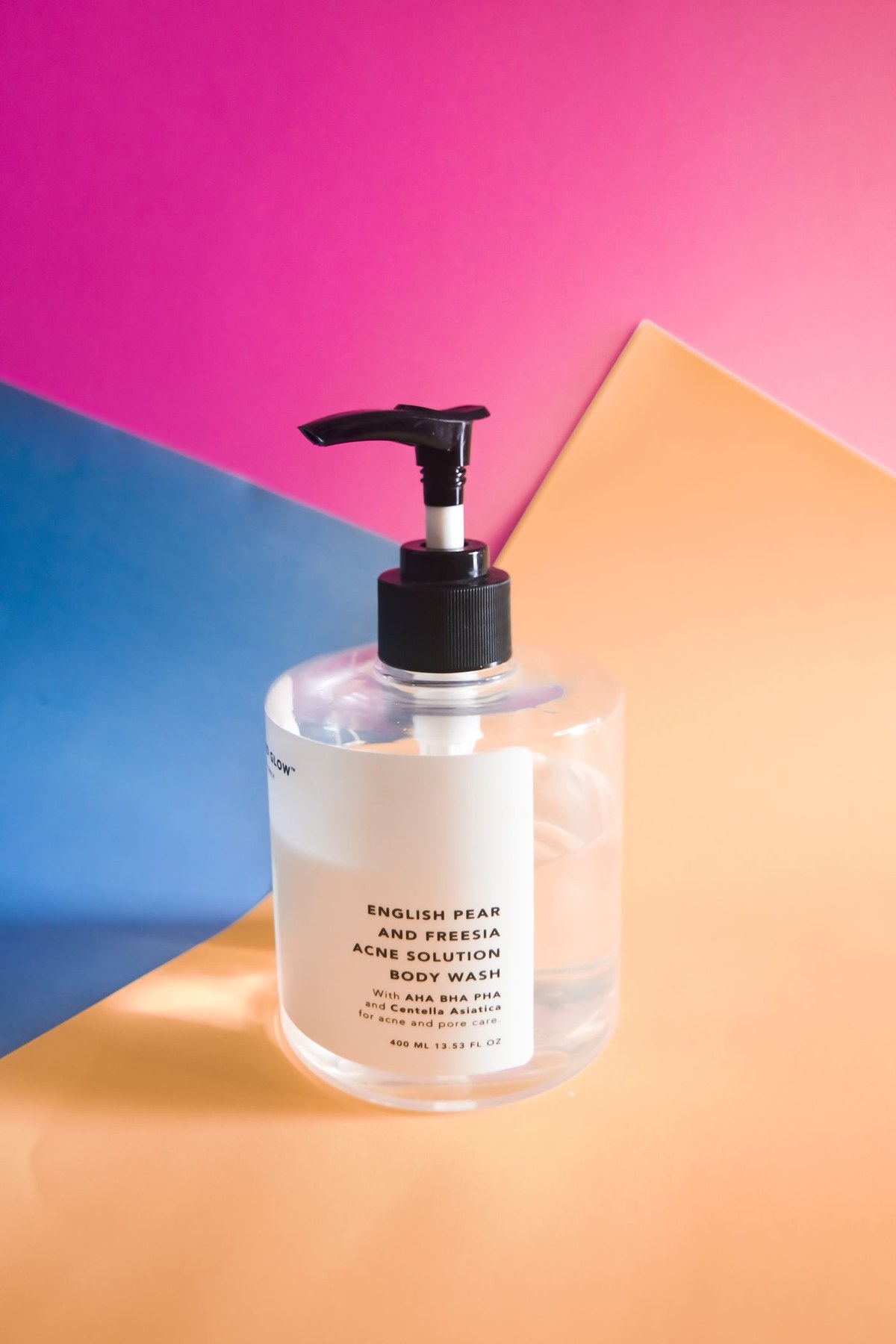 A transparent body wash bottle with its label