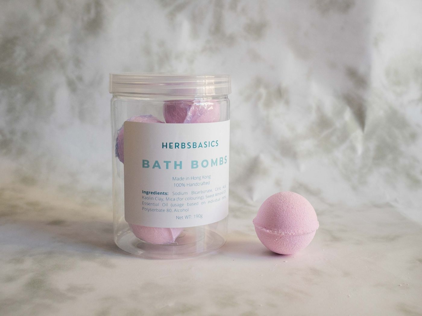 Pink bath bombs stored in a clear container