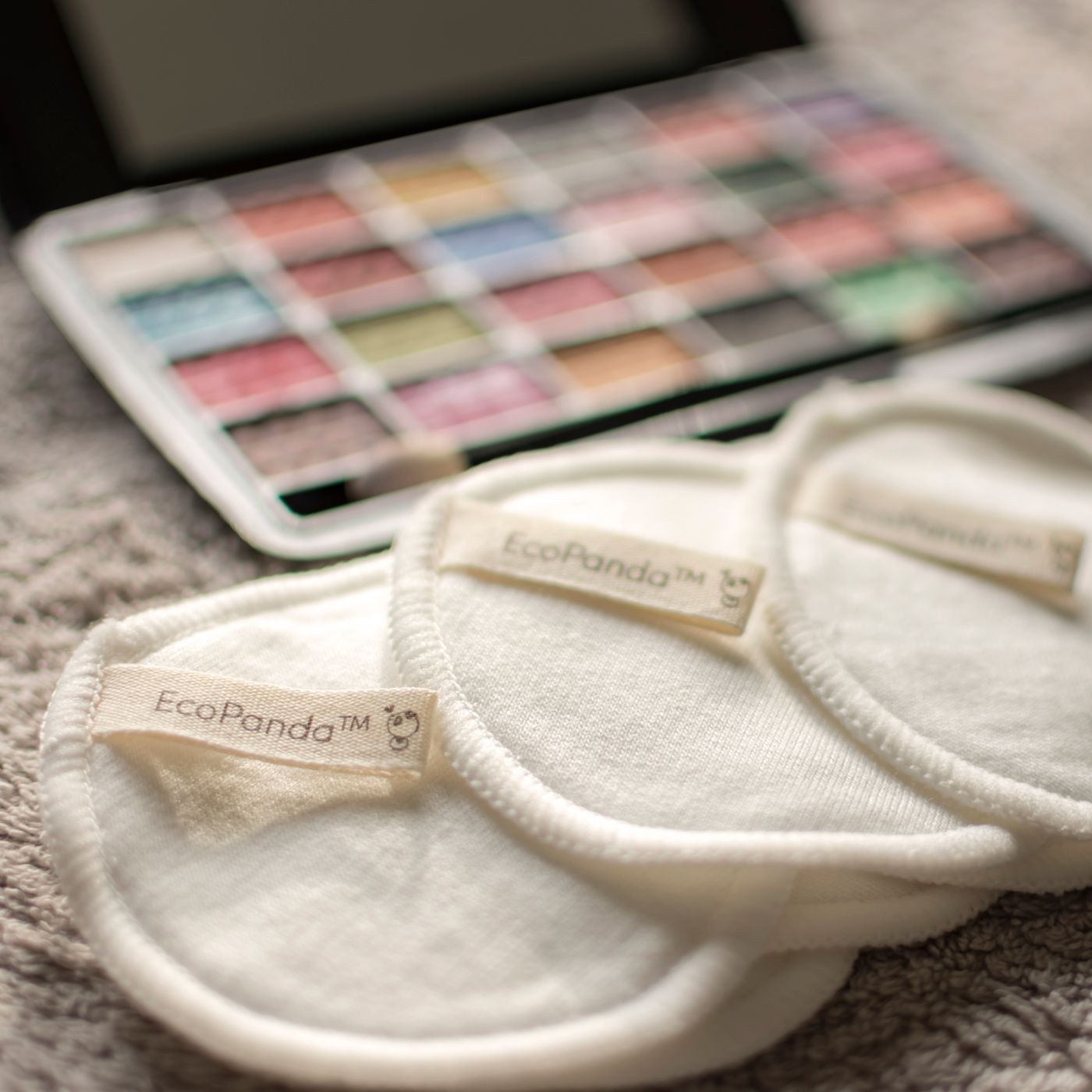 Reusable cotton pads beside makeup products