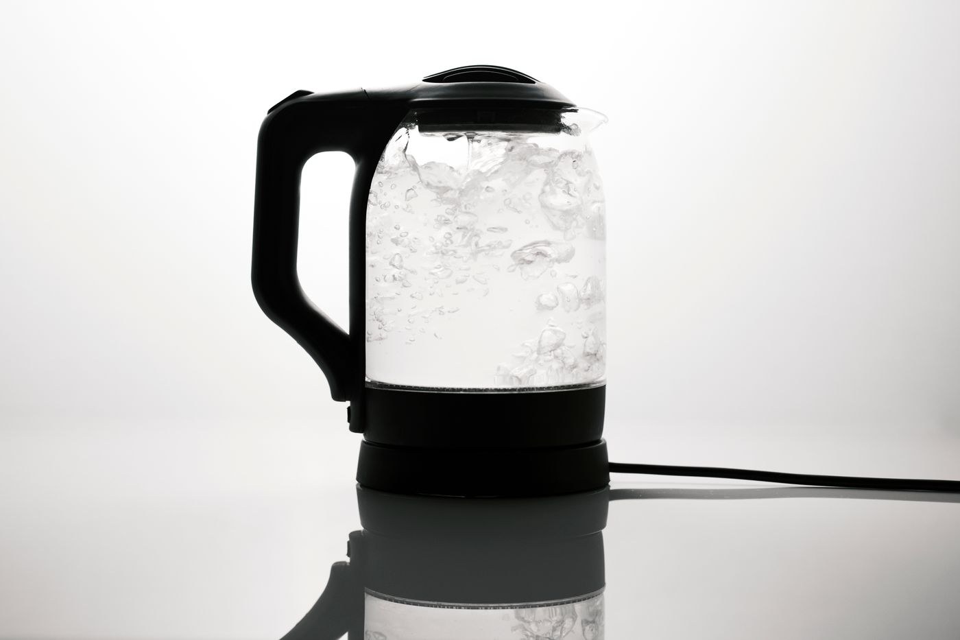 A glass electric kettle on its base