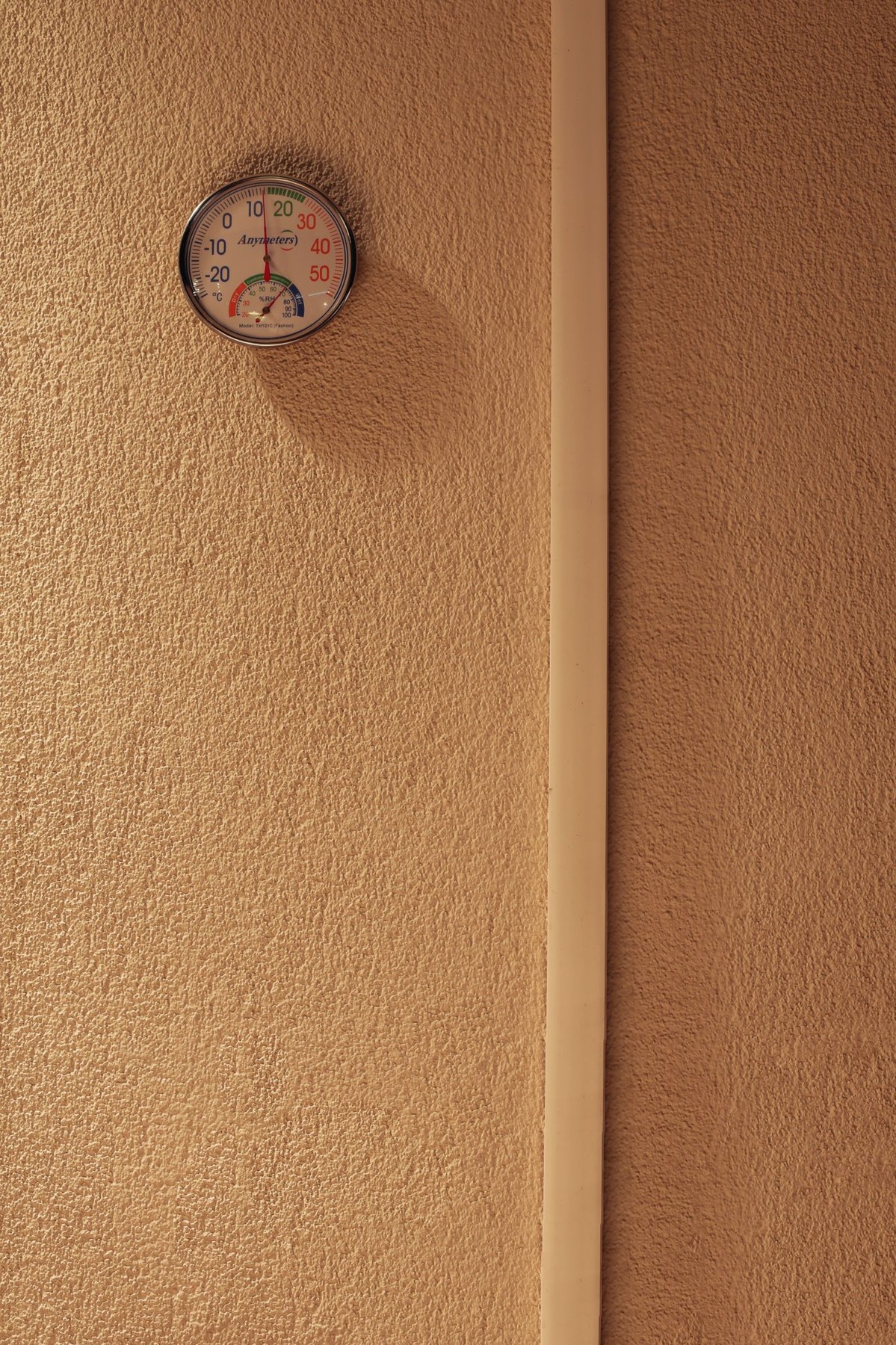 A wall-mounted humidity and temperature meter
