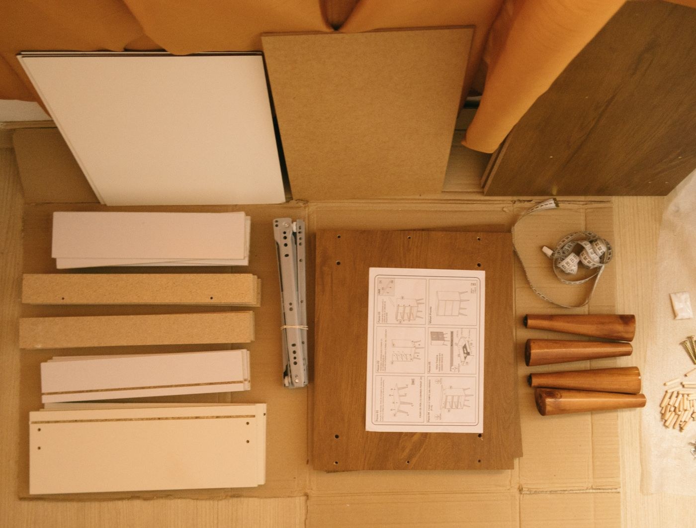 Flat-pack drawer panels beside assembly instructions